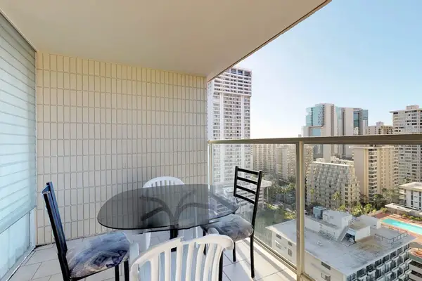 Step out onto the private tiled balcony to enjoy fresh Hawaiian breezes around the four-person, glass-topped outdoor dining table.
