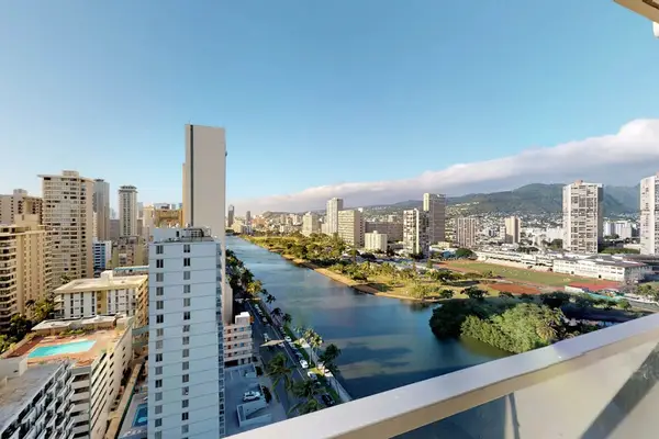Enjoy sweeping views of the nearby Ala Wai Canal, local golf course, and lush mountains directly from the private glass-railed balcony.