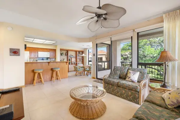 Living room showcases sofas, ceiling fan, windows, and tropical scenery