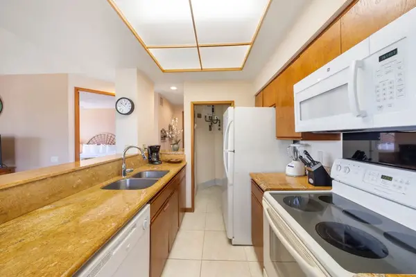 Kitchen area displays counters, appliances, cabinetry, windows, and dining seating