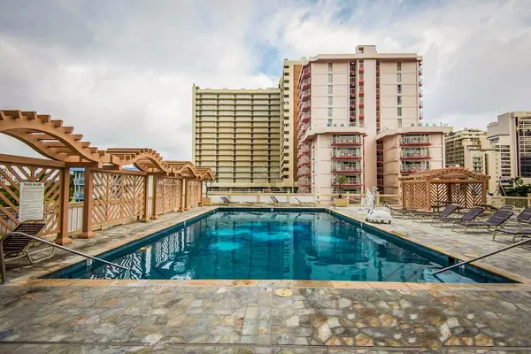 Relax beside the resort-style pool with the city skyline creating a stunning backdrop.