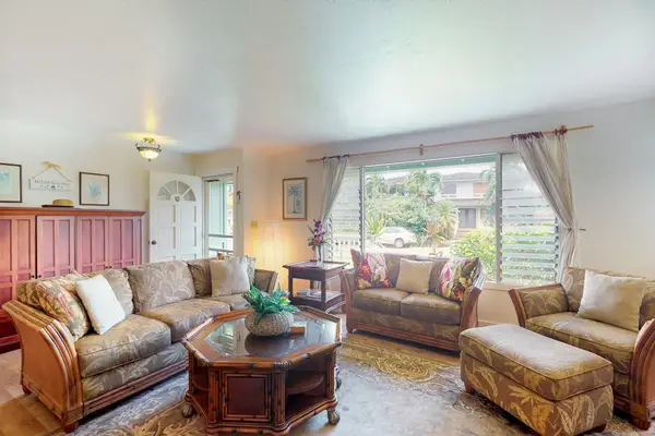 Large living room with plenty of comfortable seating for movie nights.