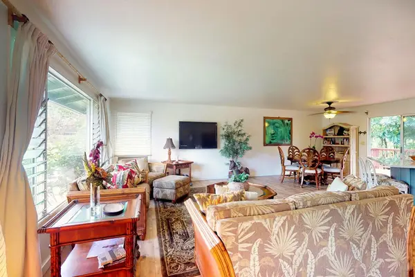 Large living room with plenty of comfortable seating and a flat screen tv for movie nights.
