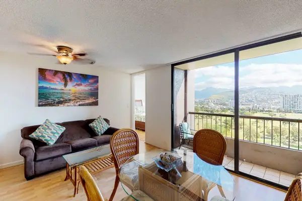 Sunlit living room and dining space with balcony views