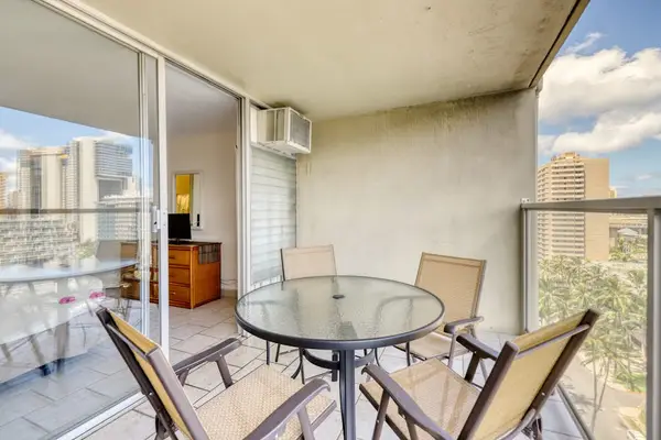 Private balcony with outdoor dining and relaxing Waikiki city views, perfect for morning coffee or sunset drinks.