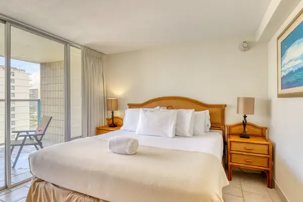 Relax in the comfortable king bedroom with private balcony access and hotel-quality linens.