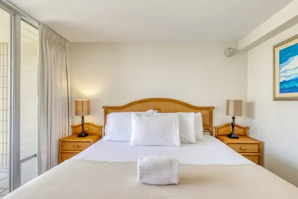 Comfortable king bedroom featuring plush linens and direct access to the private balcony.