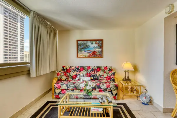 Cozy island-inspired living area with comfortable sofa bed, perfect for relaxing after your Hawaiian adventures.