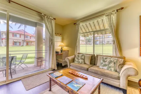 Relax in a bright and open living space featuring a glass wall that brings in natural light and beautiful views.