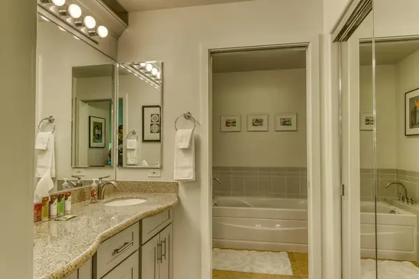 Relax and refresh in a private master bathroom featuring both a bathtub and shower for your comfort.