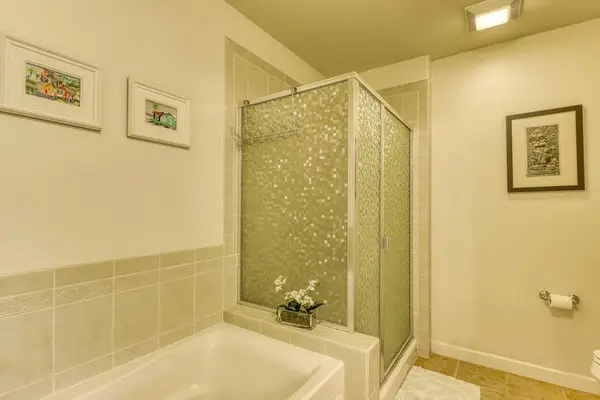 A comfortable private bathroom featuring a tub and shower for a convenient stay.