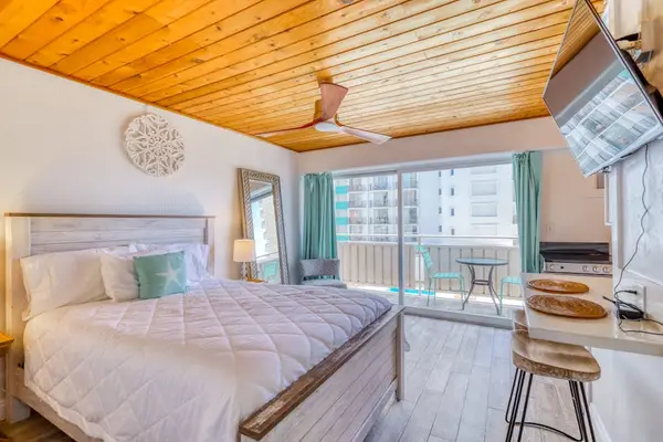 Relax in this comfortable studio featuring a queen bed and TV for restful nights and relaxing entertainment.