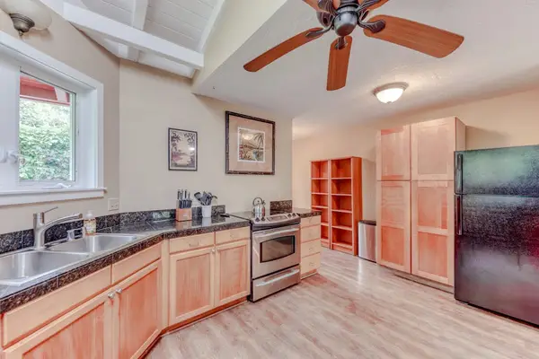 Spacious Kitchen with Wood Cabinetry & Vaulted Ceilings