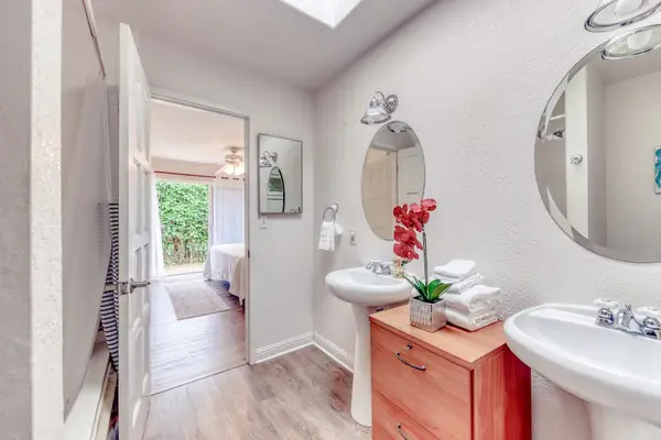 Full Primary Bathroom Featuring Double Vanity Sinks