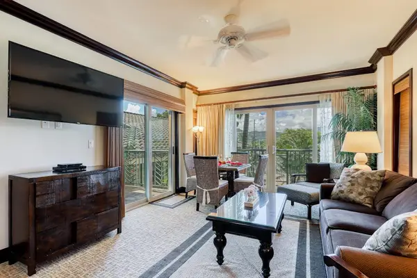 Spacious Living Room with Wall-Mounted TV & Lanai Access