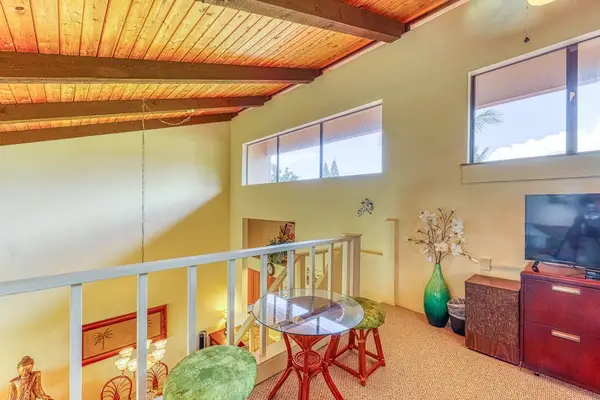 Enjoy a bird's-eye view of the main living space! This charming elevated loft features a cozy bistro table and a flat-screen TV, perfect for morning coffee or late-night movies. ☕🎬✨