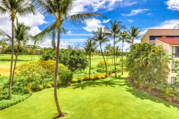Take in the view! This is the gorgeous, sun-drenched tropical landscape of palm trees and lush green lawns waiting for you right outside your balcony. 🌴☀️💚