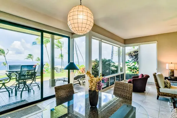 Dining room with seating for four set against the glass doors of the lanai for great natural light and even better views.
