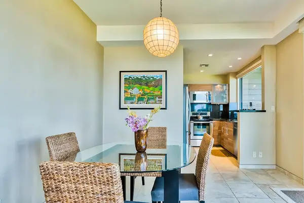 Dining room with seating for four set against the glass doors of the lanai for great natural light and even better views.