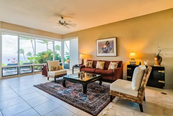 Living room with comfortable seating with floor to ceiling windows for you to take in the amazing views of your tropical paradise.