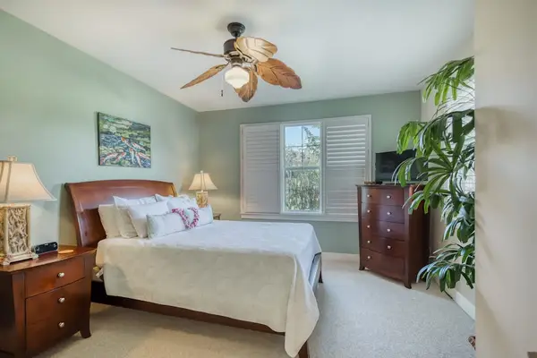 Spacious Secondary Bedroom with Tropical Accents & Ceiling Fan