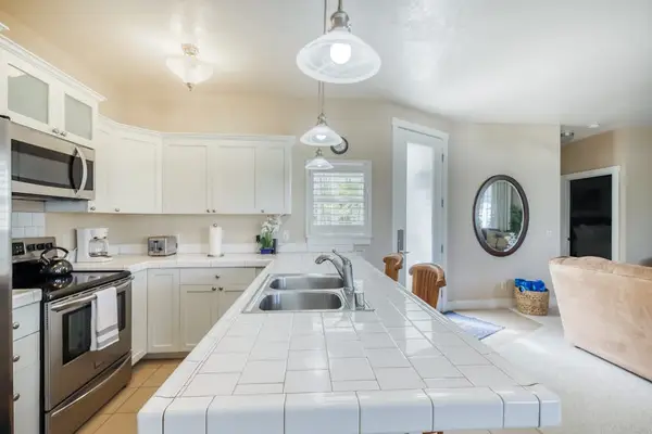 Bright Open-Concept Kitchen Leading to Living & Dining Areas