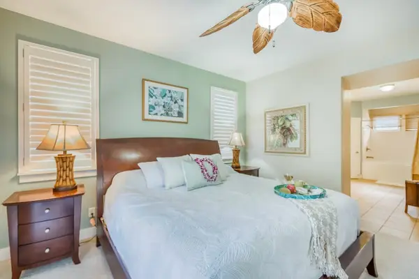 Spacious Primary Bedroom with Plush Bedding & Coastal Decor