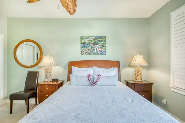 Cozy Bedroom Suite with Plush Bedding & Circular Mirror
