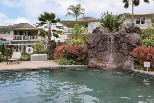 Resort-Style Swimming Pool with Waterfall Feature & Sun Loungers