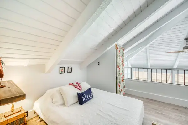 Comfortable loft bedroom with open railing