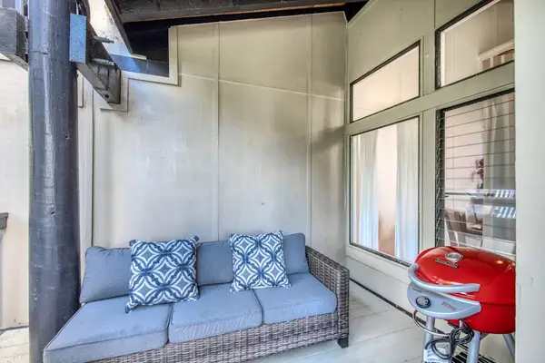 Covered Lanai Nook with Wicker Couch & Portable BBQ Grill