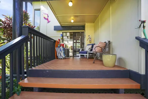 Covered Front Porch Entry with Outdoor Seating & Beach Gear
