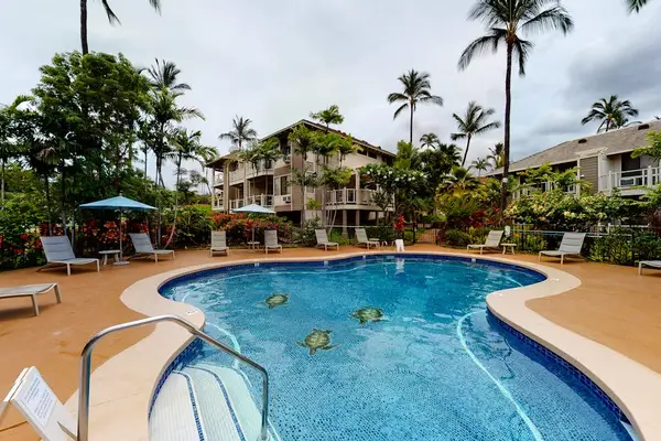 Cool off in the sparkling resort pool surrounded by palms