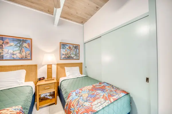 Guest bedroom with two twin beds and ample closet space.