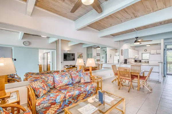 Spacious living area with comfortable seating, open to the dining space.