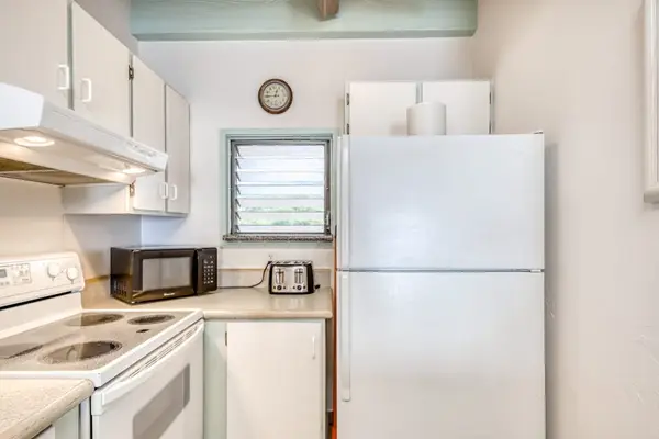 Kitchen with a full-size refrigerator and modern appliances.
