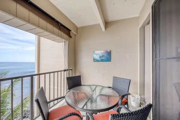 Private lanai with a dining table, perfect for meals with an ocean view.