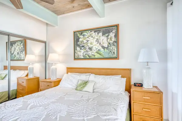 Comfortable primary bedroom with a plush bed and soft lighting.