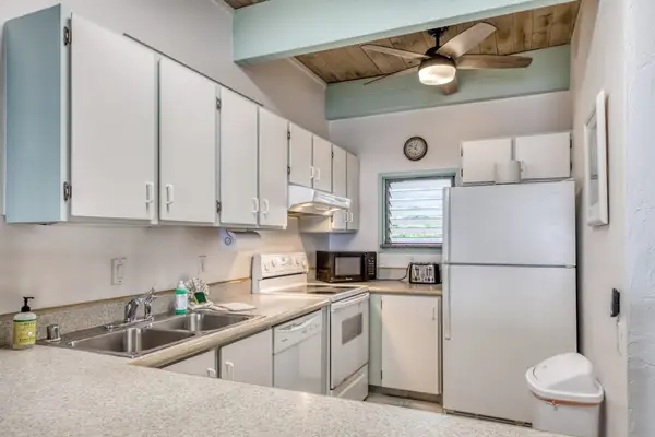 Bright kitchen with ample counter space for meal prep.