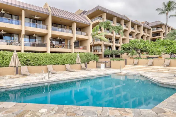 Beautiful shared resort swimming pool featuring crystal clear blue water, a paved sun deck, and manicured tropical landscaping! 🏊‍♂️☀️🌴✨