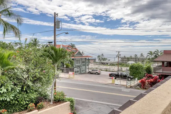 Stunning coastal ocean view from the property featuring palm trees, bright blue skies, and prime beachside location access! 🌊🌴