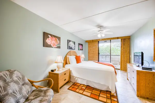 Spacious, upgraded bedroom featuring a cozy bed, modern decor, and large sliding doors for stunning views and natural light! 🏠🌅