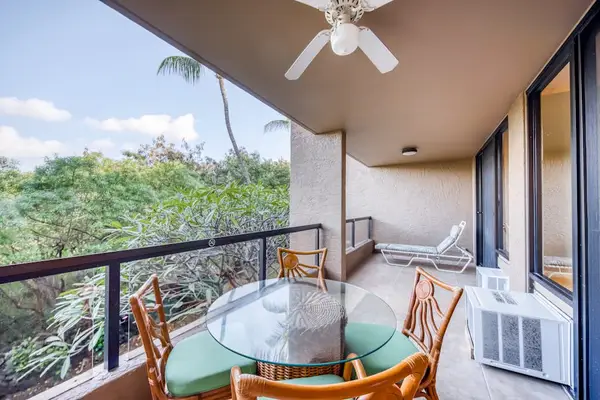 Spacious covered balcony featuring an outdoor dining table set, cushioned chairs, a cooling ceiling fan, and gorgeous, lush treetop views! 🪑🌀🌳✨
