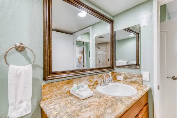 Upgraded full bathroom featuring a spacious stone vanity, large mirror, and clean walk-in shower with premium finishes! 🚿🧼