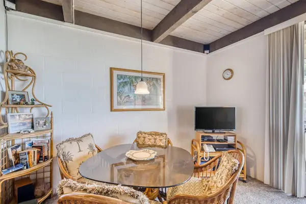 Detailed interior layout of the open living and dining area featuring premium bamboo furniture, a television corner, and high vaulted wooden ceilings! 🛋️📺✨🌴😎