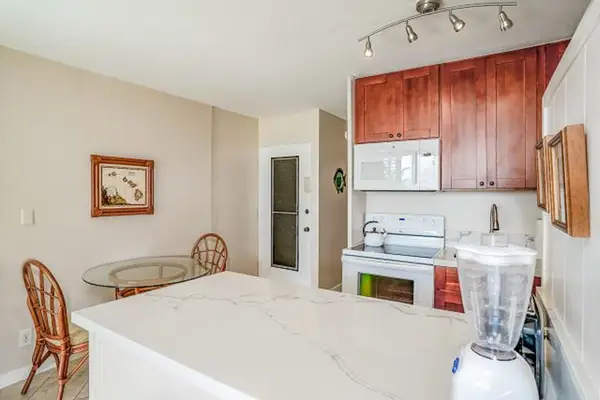 Full kitchen and a dining table for two.