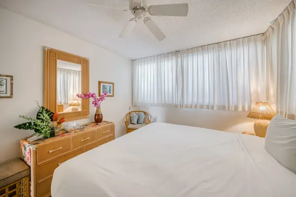 Master bedroom with a king bed, lots of natural night and a ceiling fan for comfort all night long.