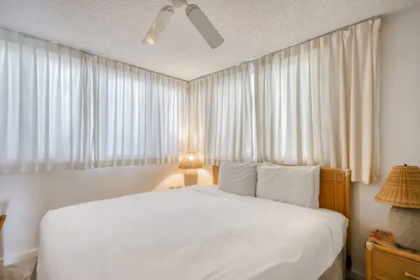 Master bedroom with a king bed, lots of natural night and a ceiling fan for comfort all night long.