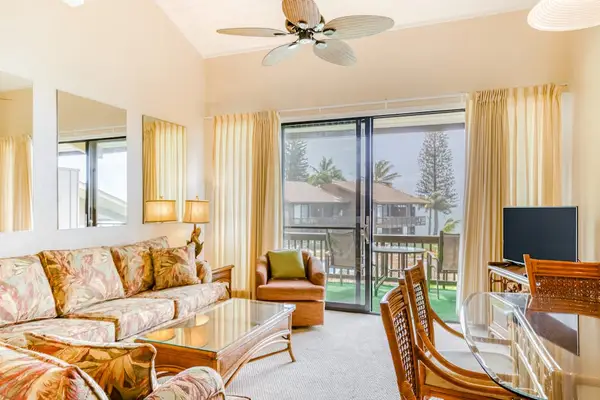 Living room with a lovely view of the lanai with a flash screen tv and sofa bed for extra company,