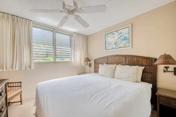 Master bedroom with king bed and ceiling fan for all night comfort.